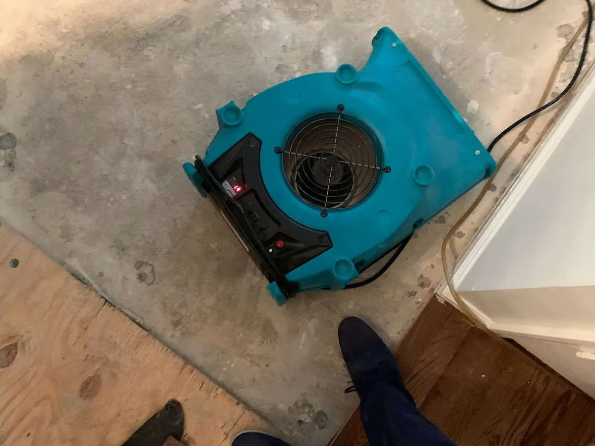 Air mover drying subfloor during Commercial Water Damage Restoration in Sandston